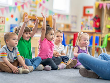 Early Learning photo of children on floor learning