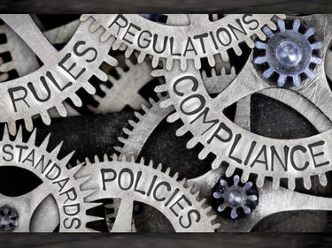 Policies photo of gears with words on them